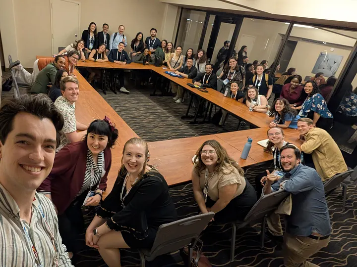 SNAP members gather around conference tables the first night of the conference.
