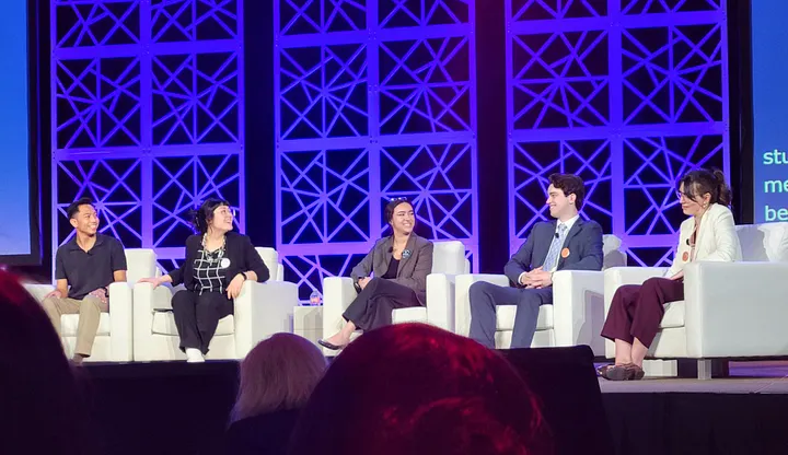 Five founding members of SNAP sit on the AAAS plenary stage answering the moderator’s questions.