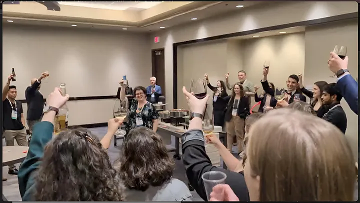 A crowd is seen toasting in celebration of SNAP and its future.