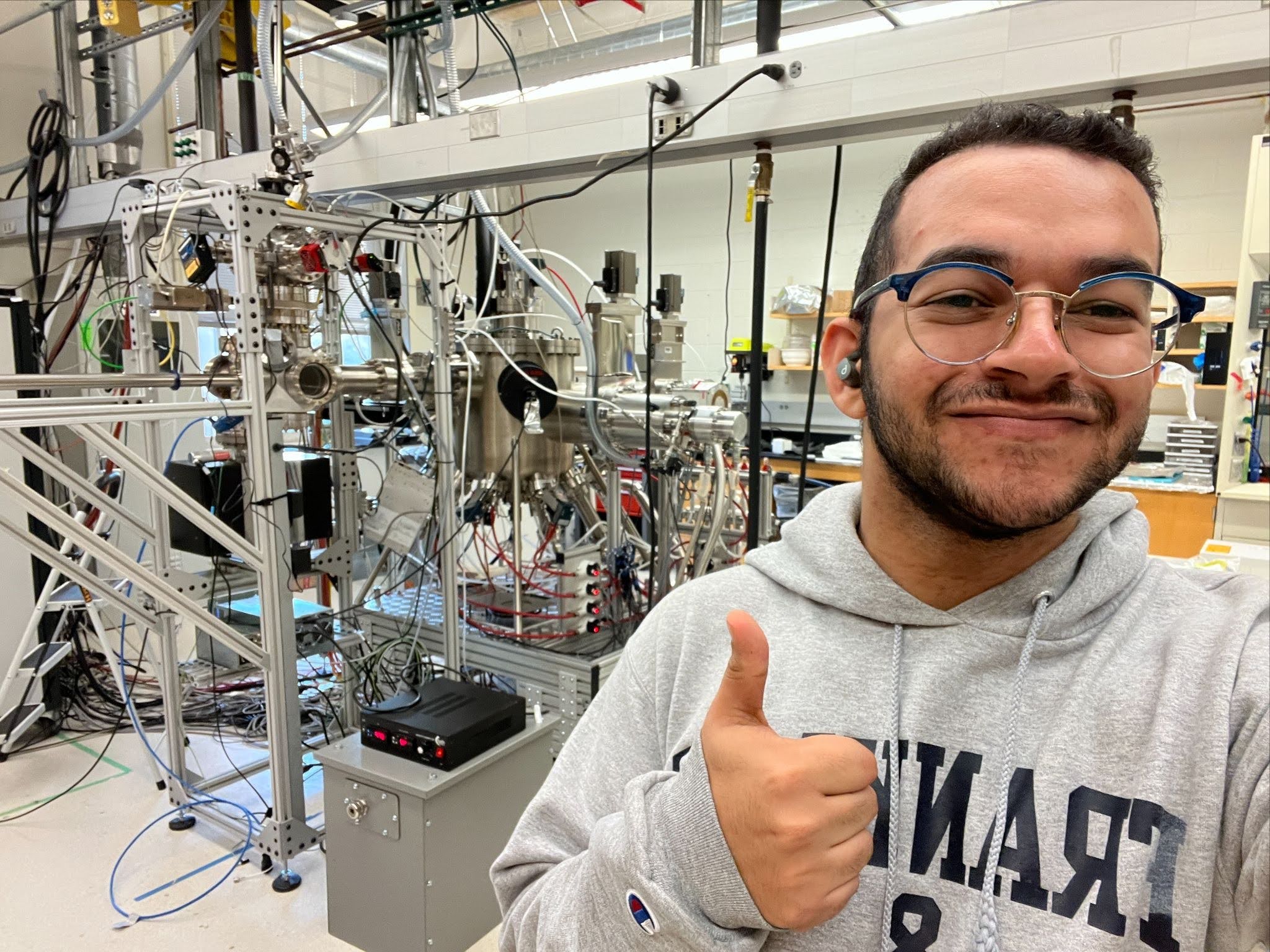 Youssef El Gharably with a Molecular Beam Epitaxy machine