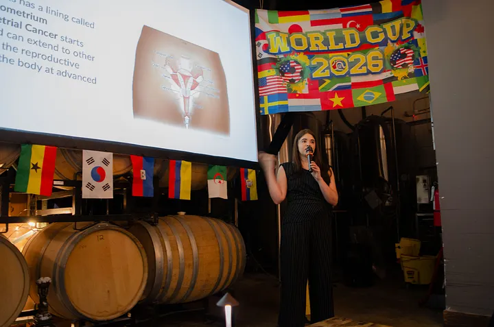 Dr. Ana Rosario Santos presenting with a microphone beside a projected slide about endometrial cancer